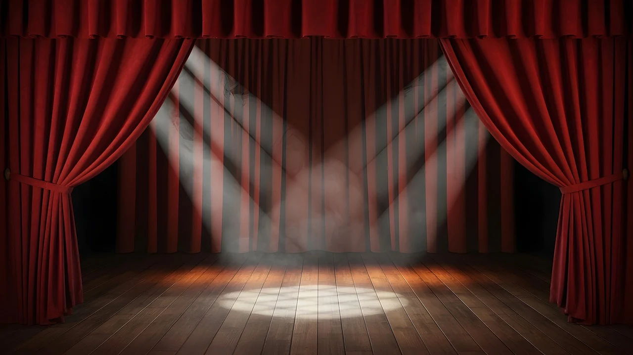Empty stage with red curtains and spotlight.